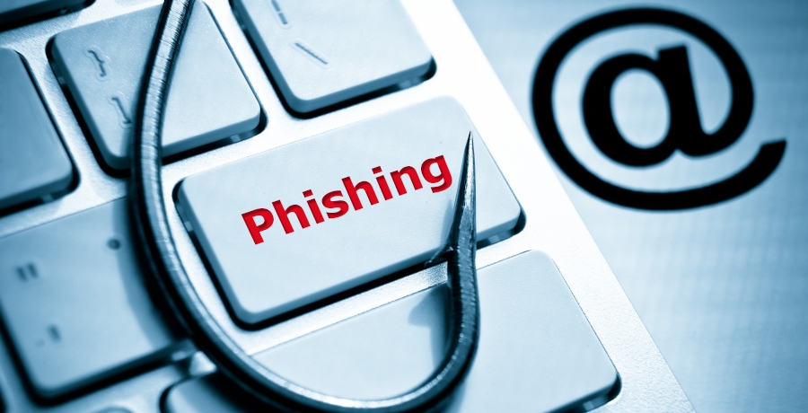 phishing / fish hook on computer keyboard with email sign