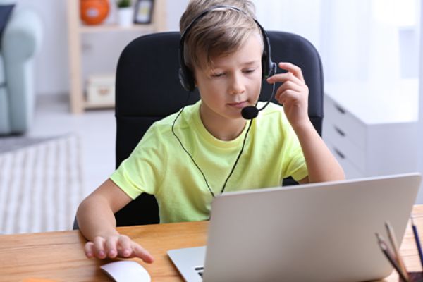 Junge spielt Serious Games vor dem Notebook
