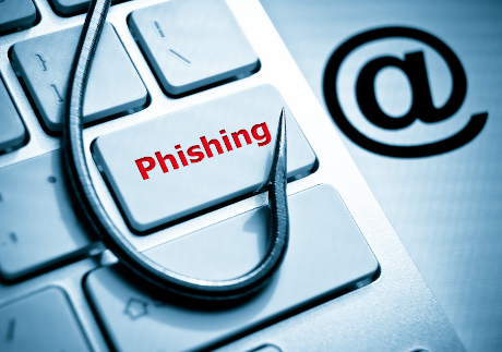 phishing / fish hook on computer keyboard with email sign